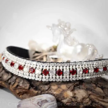 Elegant bejewelled dog collar with red gemstones close-up.