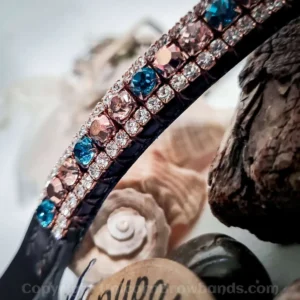 Closeup of Marine browband with blue Indicolite and rose gold crystals on black leather