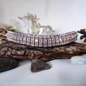 Crystal Argent Flare, Light Rose & Crystal Labrador Browband on Display: A luxury 5-row browband featuring a centre row of Crystal Argent Flare, surrounded by light rose and metallic silver Crystal Labrador crystals, showcased against rustic wood.